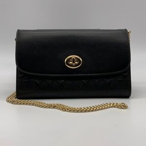 Coach black leather crossbody with embossed signature “C”.